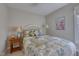 Cozy bedroom featuring a comfy bed with floral patchwork quilt and bright natural light from the large window at 48 Margaret Pl, Chapel Hill, NC 27516