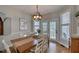 Charming dining room featuring hardwood floors, modern lighting fixture, and views to the deck at 48 Margaret Pl, Chapel Hill, NC 27516