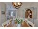 Light-filled dining room featuring a wooden table, chandelier, and a built-in china cabinet at 48 Margaret Pl, Chapel Hill, NC 27516