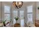 Bright dining room with modern light fixture, and white trim around windows and french doors to the outside at 48 Margaret Pl, Chapel Hill, NC 27516