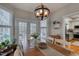 Bright dining room with wooden table and chairs, and white trim around windows and french doors to the kitchen at 48 Margaret Pl, Chapel Hill, NC 27516