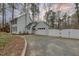 Charming two-story home with light gray siding, detached garage, and a white privacy fence at 48 Margaret Pl, Chapel Hill, NC 27516