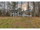 Two-story home with light gray siding, dark shutters, and a detached garage at 48 Margaret Pl, Chapel Hill, NC 27516