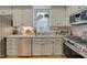 Well-lit kitchen with white cabinets, granite counters, stainless appliances, and hardwood floors at 48 Margaret Pl, Chapel Hill, NC 27516