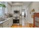 Well-lit kitchen features granite counters, stainless appliances, and an adjacent hallway at 48 Margaret Pl, Chapel Hill, NC 27516