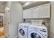 Laundry room with a washer and dryer set and white cabinets at 48 Margaret Pl, Chapel Hill, NC 27516