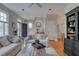 Open-concept living room with hardwood floors, featuring a staircase, a fireplace, and dining area at 48 Margaret Pl, Chapel Hill, NC 27516