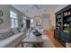 Inviting living room featuring a sofa, windows, and a dark wood bookcase in an open-concept layout at 48 Margaret Pl, Chapel Hill, NC 27516