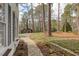 Beautiful stone walkway leading to a charming home, surrounded by lush greenery and mature trees at 48 Margaret Pl, Chapel Hill, NC 27516