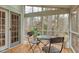 Cozy screened porch with wooded view, seating, and a table at 48 Margaret Pl, Chapel Hill, NC 27516