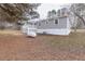Backyard of well-maintained home with porch, propane tank, and landscaping at 4814 Fayetteville Rd, Durham, NC 27713