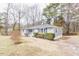 Image showcasing the exterior of a house with gray siding and blue shutters on a well-manicured lawn at 4814 Fayetteville Rd, Durham, NC 27713