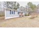 Charming single-story home with gray siding, blue shutters, and an inviting orange front door at 4814 Fayetteville Rd, Durham, NC 27713