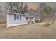 View of a cozy single-story house, featuring gray siding, contrasting trim, and well-maintained landscaping at 4814 Fayetteville Rd, Durham, NC 27713