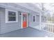 Inviting front porch with white railings and eye-catching orange door at 4814 Fayetteville Rd, Durham, NC 27713