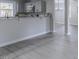 Kitchen with gray cabinets, granite countertops that opens into a living space at 4814 Fayetteville Rd, Durham, NC 27713
