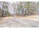 This lot features a mix of gravel and trees in a beautiful, natural setting at 4814 Fayetteville Rd, Durham, NC 27713