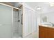 Bathroom featuring a glass-enclosed shower, tile flooring, and storage space with a wooden sink cabinet at 492 Pixley Pritchard Rd, Timberlake, NC 27583