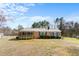 Charming single-story home with a metal roof, a covered porch, brick facade, and well-maintained landscaping at 492 Pixley Pritchard Rd, Timberlake, NC 27583