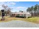 Well-kept single-Gathering house with a metal roof, a screened-in porch, and a gravel driveway at 492 Pixley Pritchard Rd, Timberlake, NC 27583
