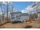 Large backyard featuring a deck, fire pit area, and mature trees at 507 Town Crier Ct, Hillsborough, NC 27278