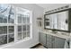 Bright bathroom with double vanity, and a large window providing lots of natural light at 507 Town Crier Ct, Hillsborough, NC 27278