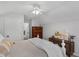 Bright bedroom features vaulted ceiling, ceiling fan, and complementary wooden furniture at 507 Town Crier Ct, Hillsborough, NC 27278