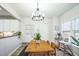 Bright dining room features a rustic wood table and a modern chandelier creating an inviting space for Gathering meals at 507 Town Crier Ct, Hillsborough, NC 27278