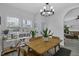 Dining area with abundant natural light, modern furnishings, and adjacent living area at 507 Town Crier Ct, Hillsborough, NC 27278