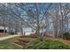Landscaped front yard showcasing the home with blue siding, white trim, and a two-car garage at 507 Town Crier Ct, Hillsborough, NC 27278
