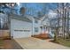 View of house with blue siding and white trim, showcasing the driveway, garage, and front yard with landscaping at 507 Town Crier Ct, Hillsborough, NC 27278