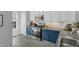 Modern kitchen featuring stainless steel appliances, blue cabinets, and stylish countertops at 507 Town Crier Ct, Hillsborough, NC 27278