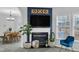 Living room featuring a fireplace with mantel, accent wall, and view into an open dining room at 507 Town Crier Ct, Hillsborough, NC 27278