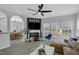Open-concept living room featuring a fireplace, large windows, and stylish furnishings, creating a cozy and inviting atmosphere at 507 Town Crier Ct, Hillsborough, NC 27278