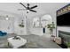 Bright and open living room with gray flooring, access to the staircase, and an archway leading to the kitchen at 507 Town Crier Ct, Hillsborough, NC 27278