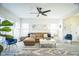 Bright living room featuring gray flooring, a comfortable seating area, and large windows for natural light at 507 Town Crier Ct, Hillsborough, NC 27278