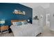 A calming main bedroom with a large bed, wood furnishings, and a striking blue accent wall at 507 Town Crier Ct, Hillsborough, NC 27278