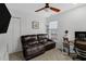 Cozy office space with a leather sofa, ceiling fan, and a practical workspace for productivity at 507 Town Crier Ct, Hillsborough, NC 27278