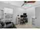 Comfortable home office features a ceiling fan, large window, and functional desk setup at 507 Town Crier Ct, Hillsborough, NC 27278