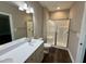 Bathroom featuring a glass shower, white vanity, and bright lighting at 512 Hicksmill Rd, Oxford, NC 27565