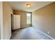 Bedroom with neutral carpet, window, and large closet with white door at 512 Hicksmill Rd, Oxford, NC 27565