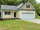 Charming, newly built home featuring yellow siding, a covered porch, and a two-car garage at 512 Hicksmill Rd, Oxford, NC 27565