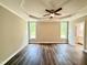Primary bedroom with tray ceiling, ceiling fan, and large windows bringing in natural light at 512 Hicksmill Rd, Oxford, NC 27565