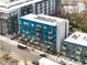 Modern building showcasing a blue and grey facade with multiple balconies and street view at 515 N Mangum St # 14, Durham, NC 27701