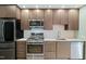 Well-equipped kitchen with stainless steel appliances, sleek cabinetry, and white subway tile backsplash at 515 N Mangum St # 14, Durham, NC 27701