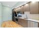 Contemporary kitchen with stainless steel appliances, stylish cabinets, and white countertop at 515 N Mangum St # 14, Durham, NC 27701