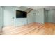 Stylish living room with hardwood floors, modern lighting, and a wall-mounted television at 515 N Mangum St # 14, Durham, NC 27701