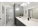 Bathroom featuring gray cabinets, white countertops, modern lighting and views into the shower and toilet at 5213 Bent Leaf Dr, Raleigh, NC 27606