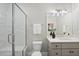 Bright bathroom features a glass shower, modern vanity, and stylish lighting fixtures at 5213 Bent Leaf Dr, Raleigh, NC 27606