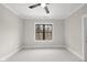 Bedroom with neutral walls, a black ceiling fan, and a black trimmed window with view of foliage at 5213 Bent Leaf Dr, Raleigh, NC 27606